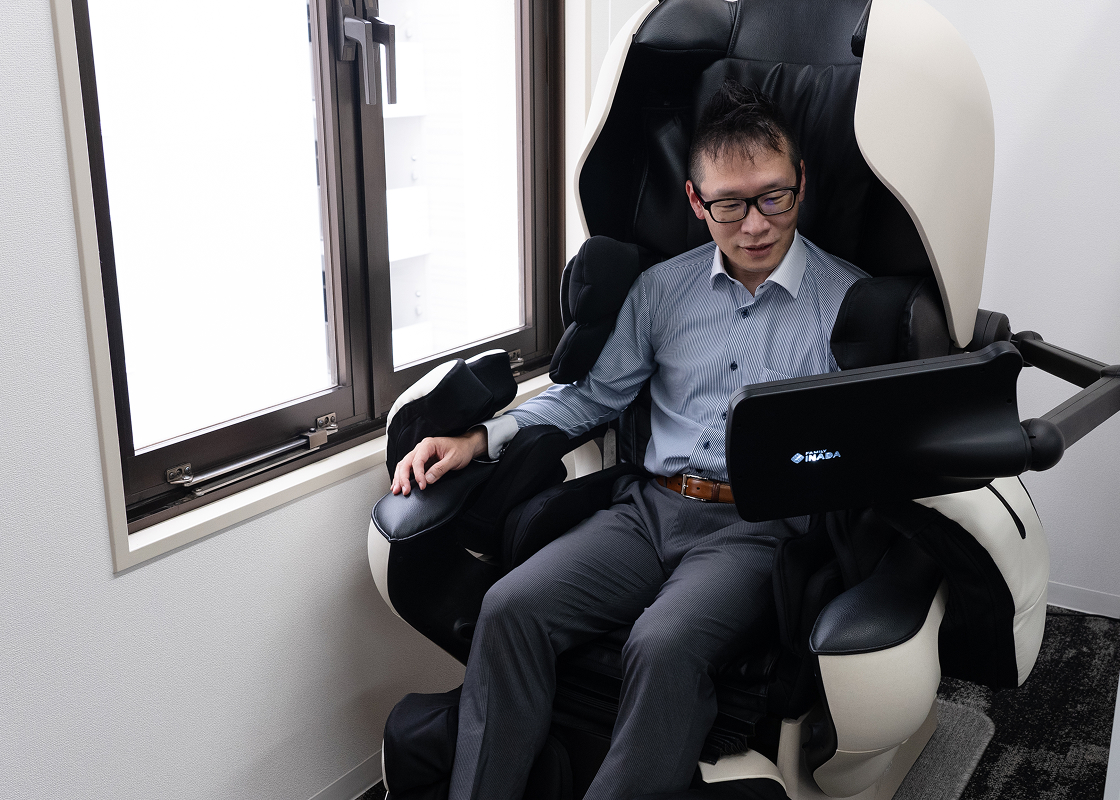 マッサージ機を操作する男性社員